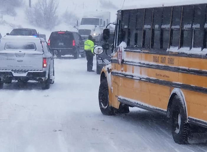 The Douglas County School District deploys school buses to help stranded motorists on I-25, among other highways, on March 13. By 7 p.m., the buses had rescued and transported more than 100 people.